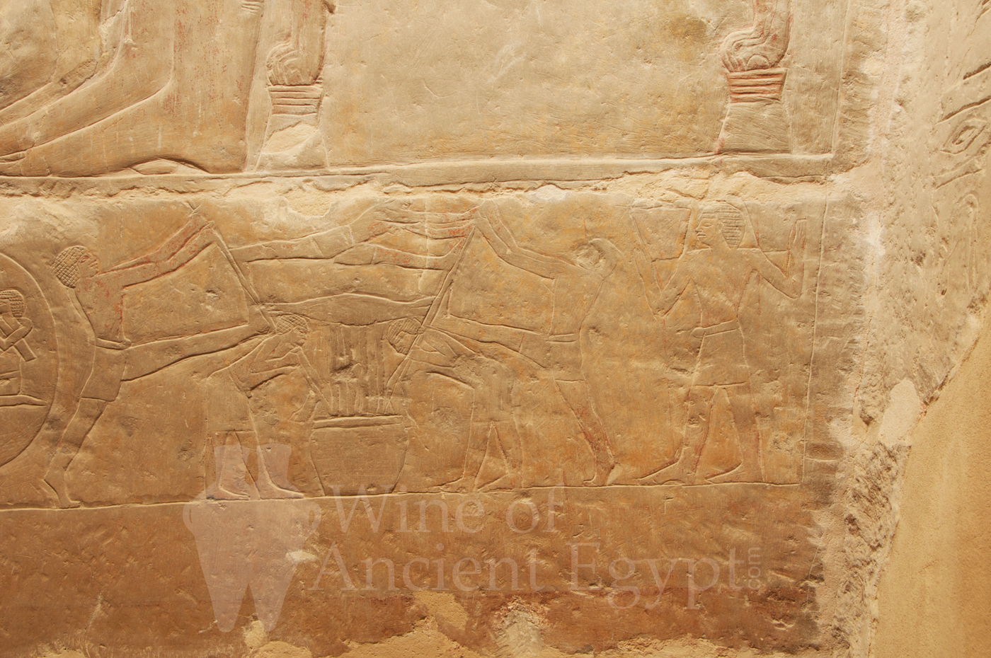 Men working a wine sack-press and a man carrying two baskets of grapes. Mereruka. Saqqara. Dynasty 6